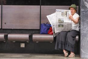 Женщина читает газету